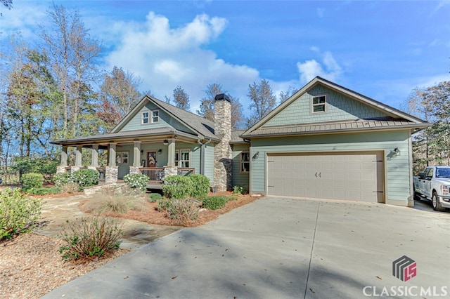 craftsman inspired home with covered porch and a garage