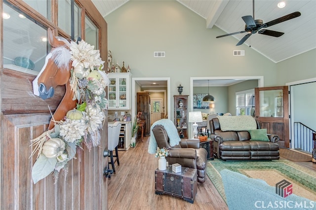 living room featuring wooden ceiling, high vaulted ceiling, light hardwood / wood-style flooring, ceiling fan, and beam ceiling