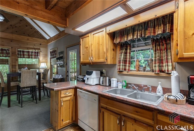 kitchen featuring kitchen peninsula, vaulted ceiling with beams, white dishwasher, and sink