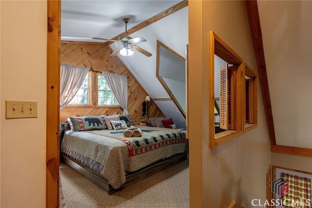 bedroom with lofted ceiling with beams, ceiling fan, and wood walls