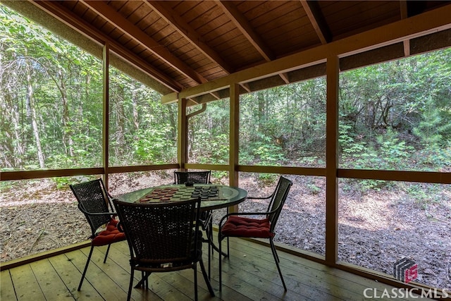 unfurnished sunroom with lofted ceiling with beams and wood ceiling