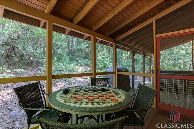 sunroom with lofted ceiling with beams and wood ceiling