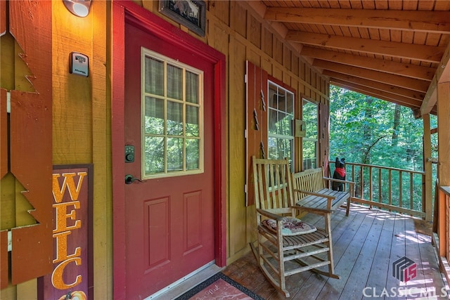 view of exterior entry with covered porch