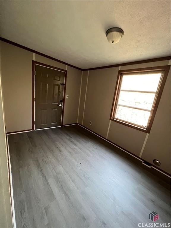 interior space featuring hardwood / wood-style floors and crown molding