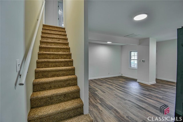 staircase with hardwood / wood-style flooring