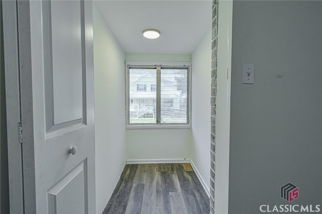 hallway with dark hardwood / wood-style flooring