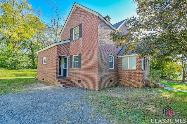 view of side of property with a lawn