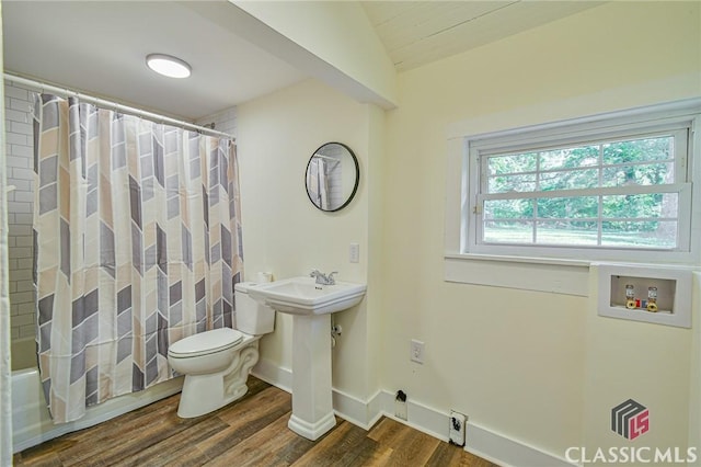 full bathroom with shower / bath combination with curtain, sink, vaulted ceiling, hardwood / wood-style flooring, and toilet