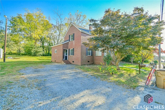 view of side of home with a lawn