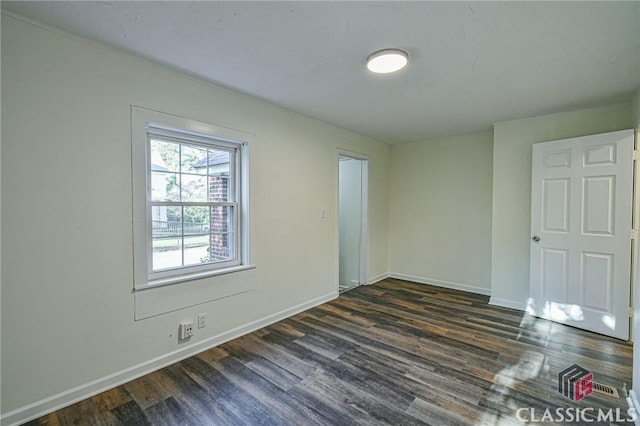 unfurnished room featuring dark hardwood / wood-style floors