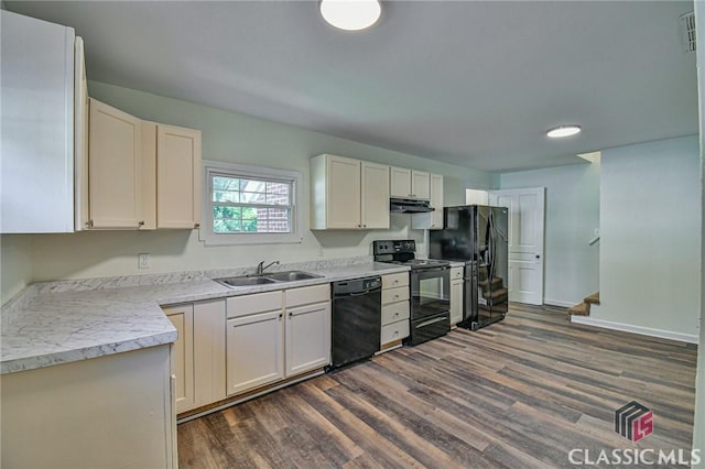 kitchen featuring sink, white cabinetry, dark wood-type flooring, and black appliances