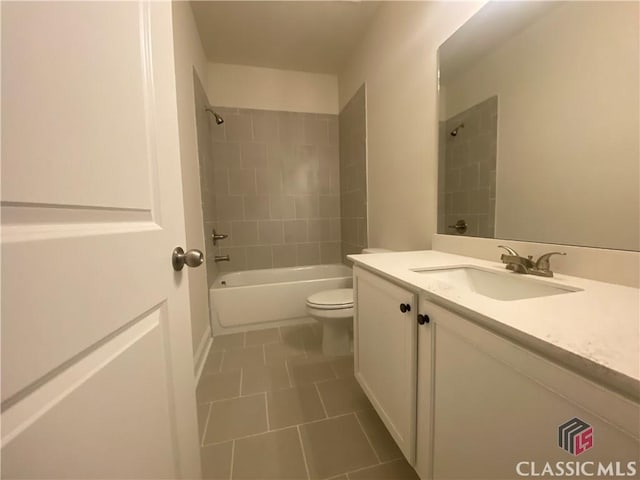 full bathroom with vanity, toilet, and tiled shower / bath