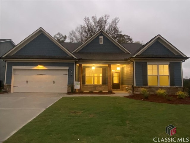 craftsman-style home featuring a front yard and a garage