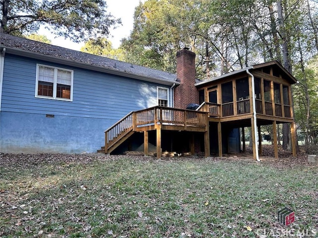 rear view of property with a lawn and a deck