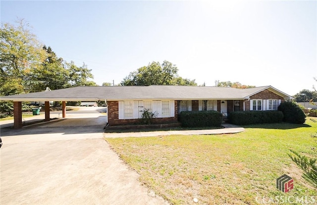 single story home with a front yard and a carport