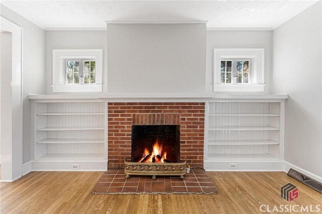 interior space with a fireplace, wood-type flooring, and a textured ceiling