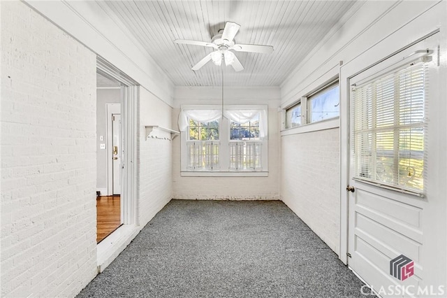 unfurnished sunroom with ceiling fan