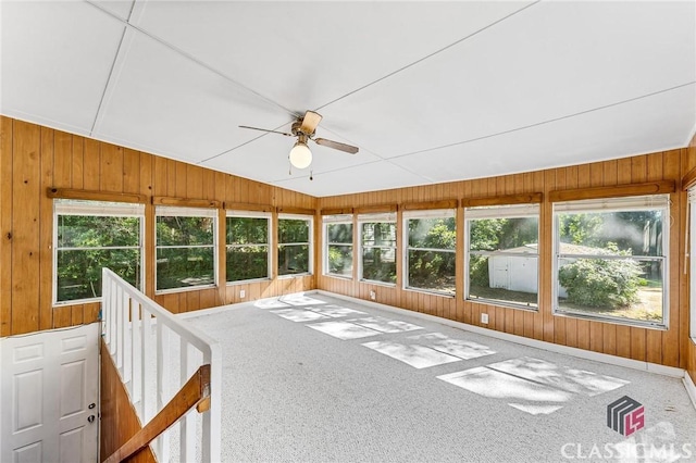 unfurnished sunroom with ceiling fan, a healthy amount of sunlight, and vaulted ceiling