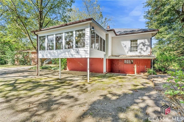 back of house with a sunroom