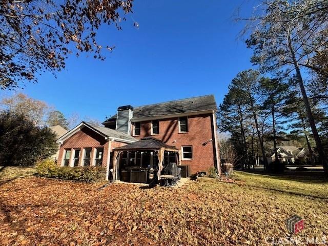 back of house featuring a gazebo