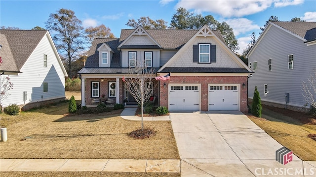 craftsman house with a garage, a front yard, and a porch