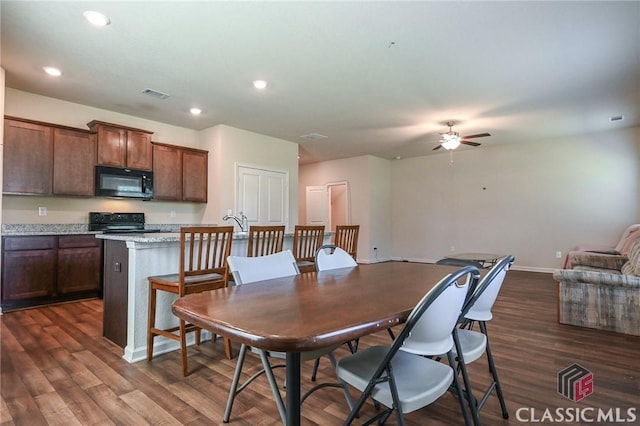 dining room with ceiling fan and dark wood-type flooring