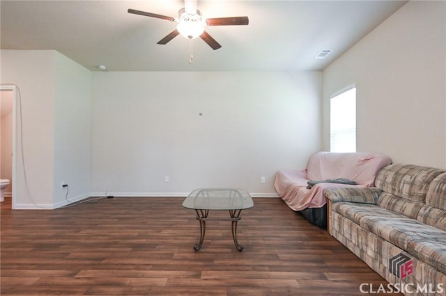 living room featuring ceiling fan and dark hardwood / wood-style flooring