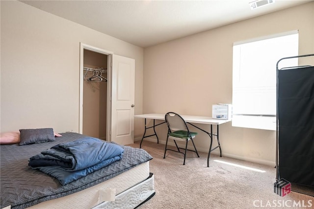 bedroom featuring light carpet, a closet, and a spacious closet