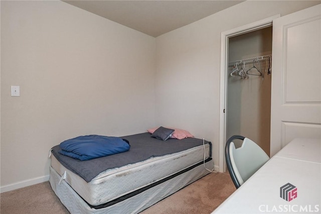 bedroom with light colored carpet and a closet