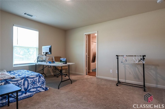 bedroom with carpet floors and a textured ceiling