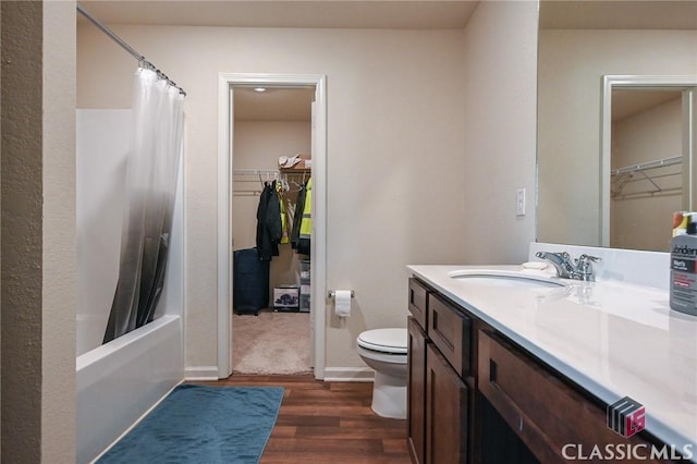 full bathroom featuring hardwood / wood-style floors, vanity, toilet, and shower / bath combination with curtain