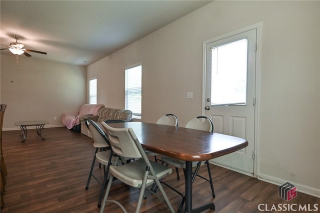 dining space with ceiling fan and dark hardwood / wood-style flooring