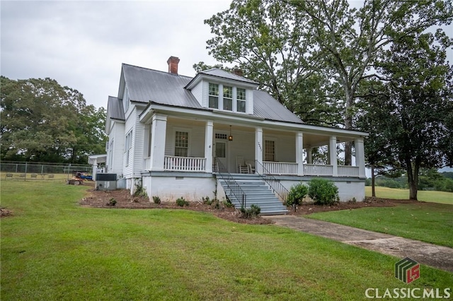 view of front of house with covered porch and a front yard