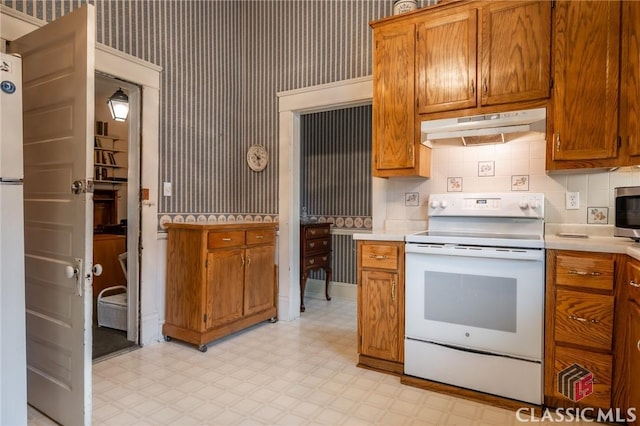 kitchen with white appliances and tasteful backsplash