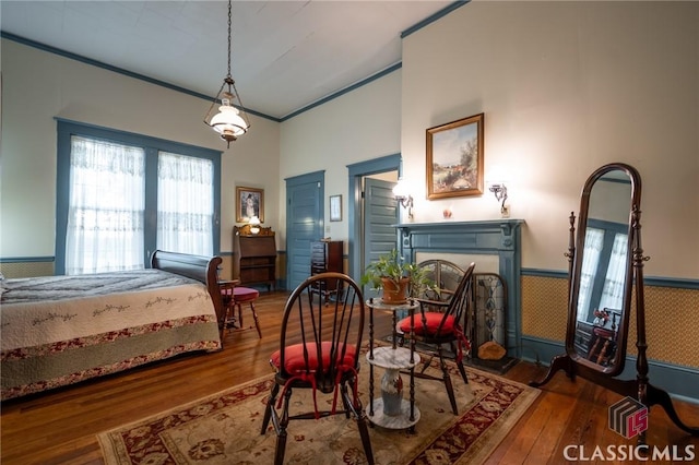 bedroom with hardwood / wood-style floors and ornamental molding