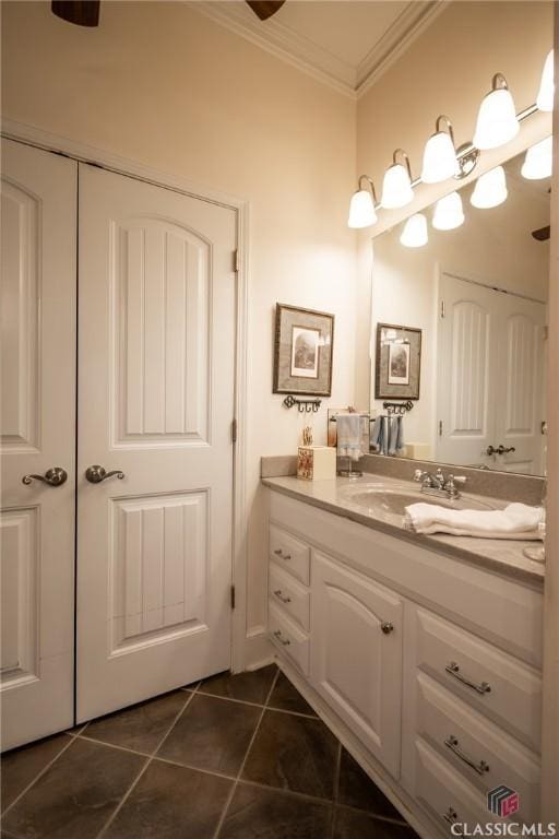 bathroom with tile patterned flooring, vanity, and crown molding