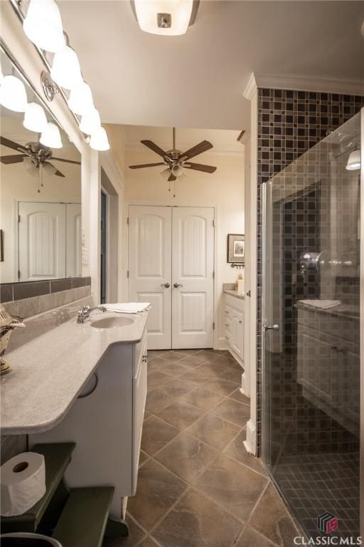 bathroom with vanity, an enclosed shower, and ornamental molding