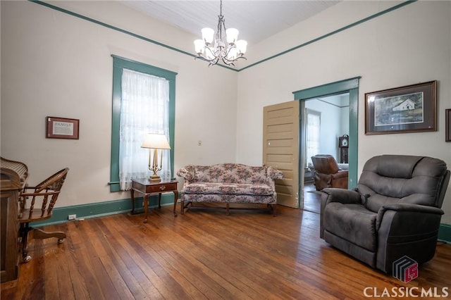 living room featuring hardwood / wood-style floors and an inviting chandelier