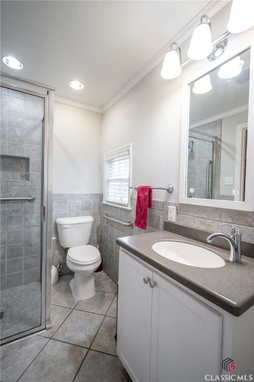 bathroom featuring vanity, tile patterned floors, ornamental molding, tile walls, and walk in shower