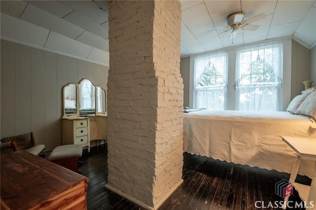 bedroom featuring ceiling fan, dark hardwood / wood-style flooring, and lofted ceiling