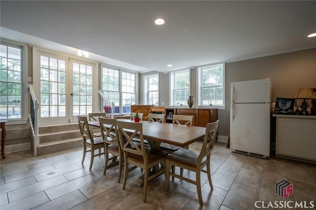 tiled dining room featuring plenty of natural light