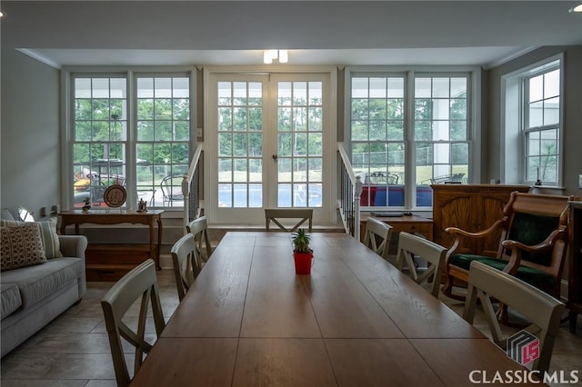 interior space featuring crown molding, french doors, and tile patterned flooring