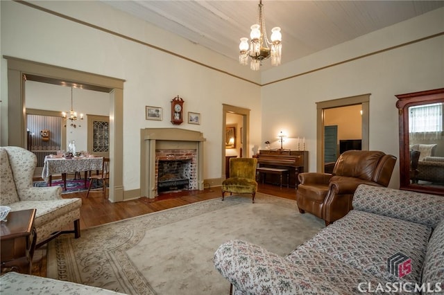 living room with hardwood / wood-style floors and an inviting chandelier