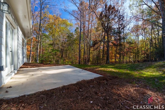 entry to storm shelter featuring a yard and a patio area