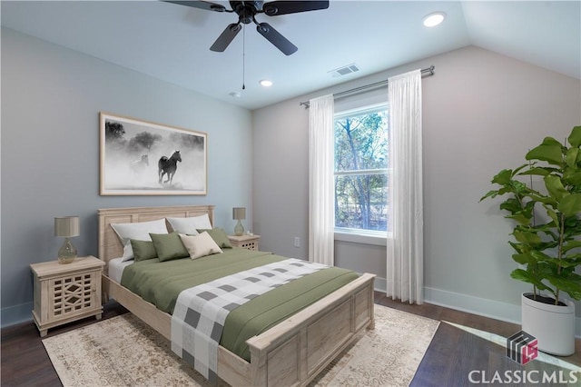 bedroom with multiple windows, dark hardwood / wood-style flooring, vaulted ceiling, and ceiling fan