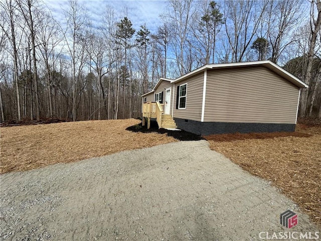 view of home's exterior with crawl space