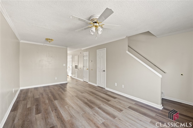 unfurnished living room with wood-type flooring, a textured ceiling, ceiling fan, and crown molding