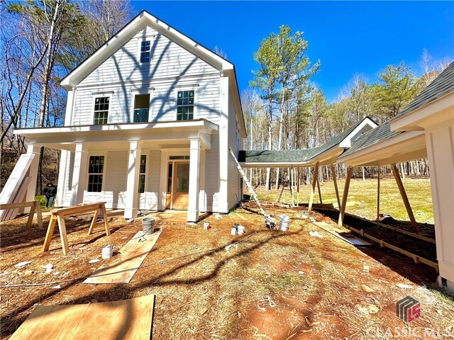 rear view of property with a porch