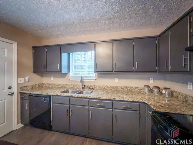 kitchen featuring a textured ceiling, dark hardwood / wood-style flooring, sink, and black appliances