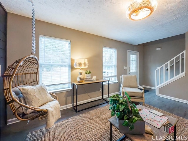 sitting room featuring a textured ceiling and a healthy amount of sunlight